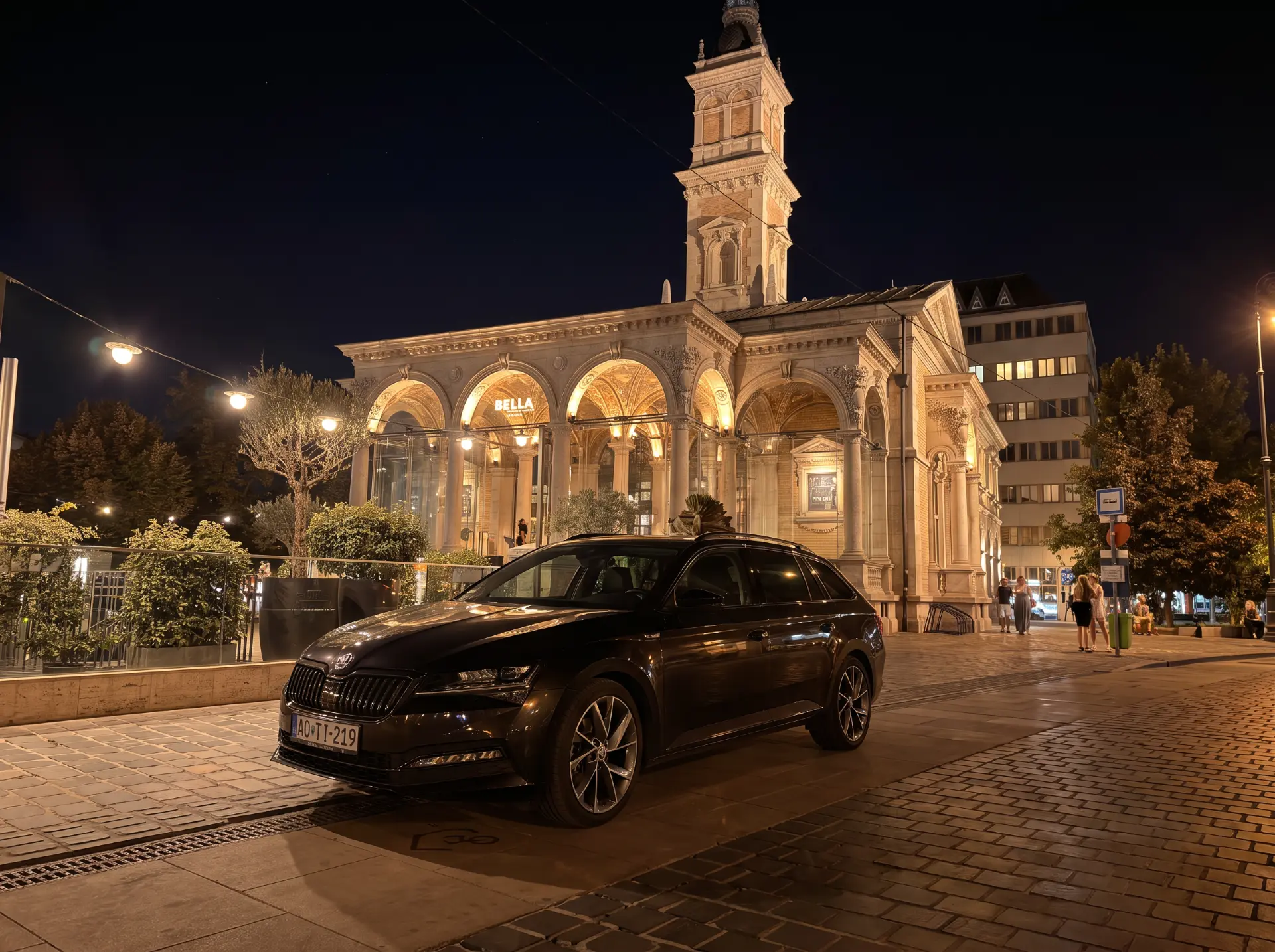 Black Skoda Superb in Budapest at night with city lights