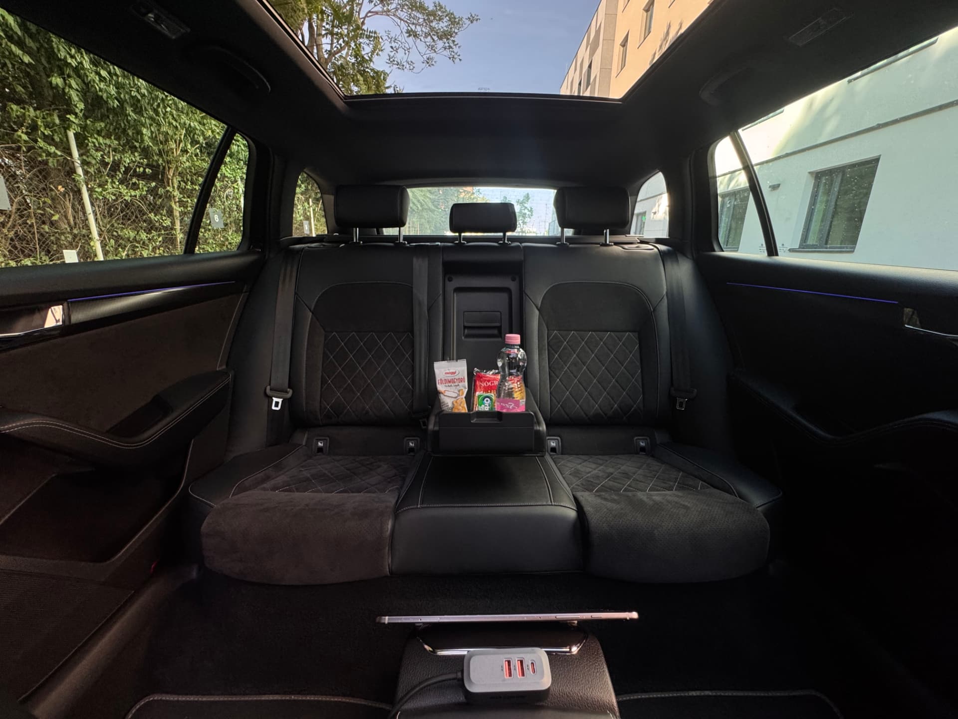 Rear seats of the Skoda Superb with panoramic glass roof, chilled refreshments and USB charging