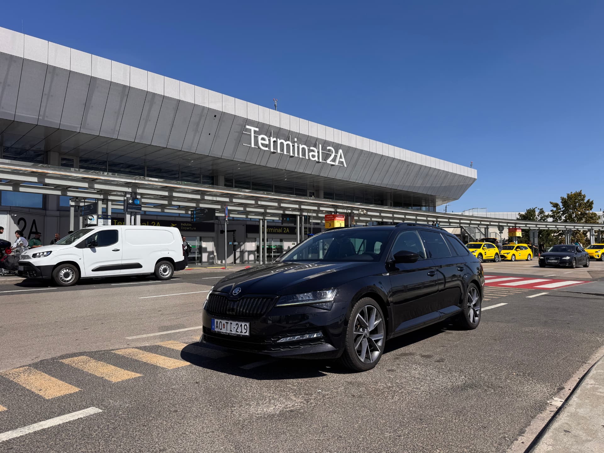 Black Skoda Superb at the airport terminal